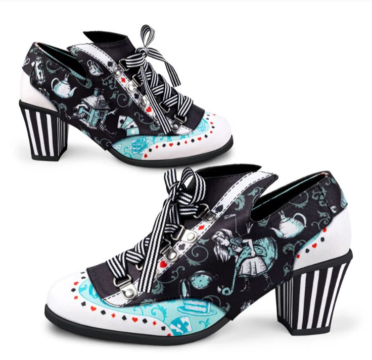the image shows two highheeled shoes with an "alice in wonderland" theme. the shoes feature a black and white stripe design on the heels and laces. the fabric on the shoes has a pattern of alice in wonderland characters, teapots, playing cards, and other whimsical elements. the toe part of the shoe is white with small red hearts and blue accents. the shoes have a quirky and novelty design, appealing to fans of the story.