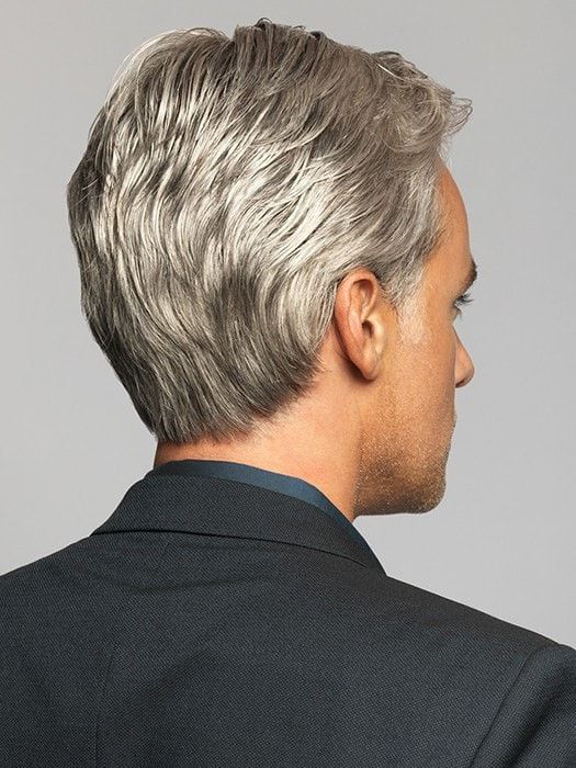 the image showcases the back of a man's head, highlighting his short, styled gray hair. he wears a black suit jacket, suggesting a professional setting. the studio lighting accentuates the details of his haircut and hair color.