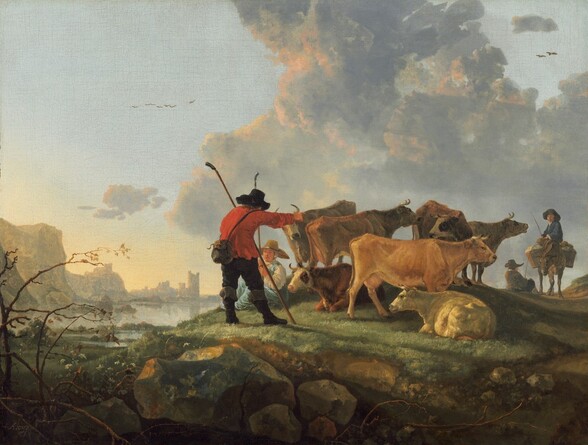 a landscape painting depicts a herd of cows being guided by a shepherd and another figure, with a boy riding a donkey in the background. the scene is set on a grassy hill with rocks, overlooking a river and a city in the distance. mountains and a cloudy sky fill the backdrop. a shepherd in a red coat and hat stands in the foreground, holding a stick. several cows are grazing or resting on the hill. the painting is in the style of the dutch golden age.