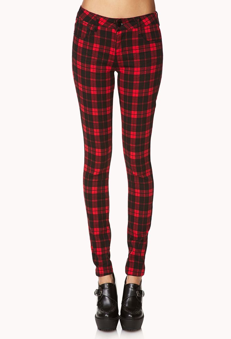 a full shot shows a pair of red and black tartan plaid pants. the pants have a button and a small pocket on the front. the hem of the pants stops above a pair of black leather heeled shoes with a strap and silver buckle.