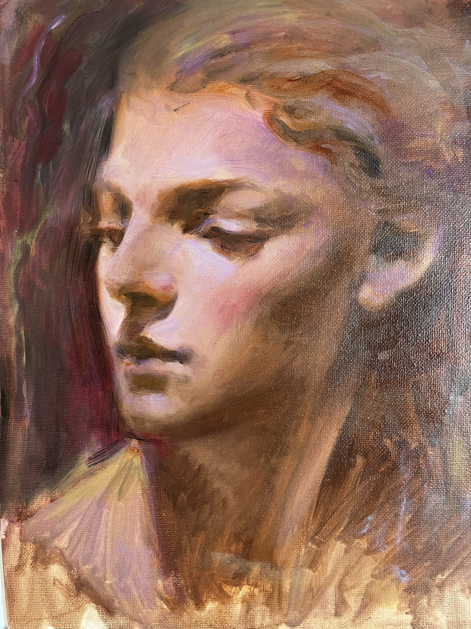 this is a portrait oil painting of a young woman with a contemplative expression. her soft features are painted with delicate brushstrokes, and her hair is a mass of rich, dark brown. the background is a warm, earthy tone, which helps to create a sense of intimacy and warmth. the painting is both realistic and impressionistic, capturing the essence of the woman's beauty and her quiet, thoughtful demeanor.