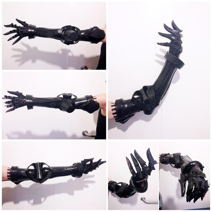 this image shows a black 3d printed robotic arm with claws, likely for cosplay or prop use.  the arm is made with a black material and has a detailed, realistic design.  it appears to be a prosthetic arm that resembles a robotic appendage, with various joints and segmented parts.  the arm is shown from different angles, revealing its intricate design and detail. it has a robotic hand, with sharp claws and a intricate, detailed design that looks robotic. it's a compelling and unique cosplay item or a scifi prop.