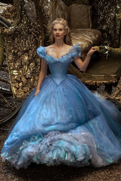 a beautiful woman wearing a stunning blue ball gown is standing in front of a grand carriage. the dress is shimmering and sparkling, and the woman looks like a real life princess. the carriage is decorated with gold and looks like it is straight out of a fairytale. the whole scene is magical and elegant.
