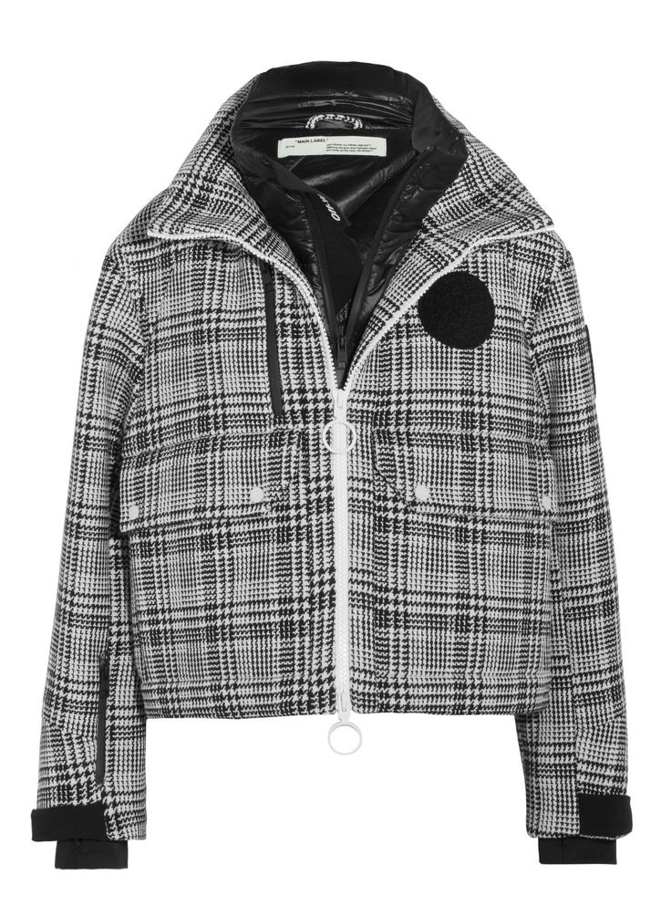 a black and white plaid jacket with a zipper down the front. the jacket has a black collar and sleeves, and two pockets on the front.