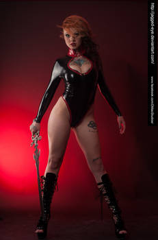 a striking portrait of a redhead woman in a black latex bodysuit with red accents. she is holding a dagger and wearing highlaced platform boots. the background is a deep red, enhancing the dramatic and sultry mood. the overall style is a blend of gothic, fantasy, and glamour, showcasing a confident and powerful female figure.