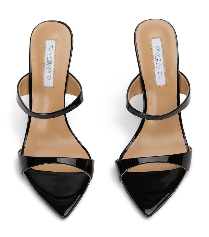 a pair of black patent leather high heeled sandals with pointed toes. they have two straps around the ankle and a stiletto heel. the heels have a "tony bianco" label on the inside. the sandals are perfect for a dressy occasion or a night out.