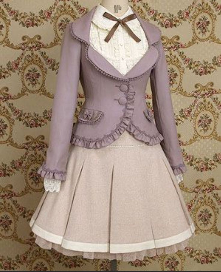 a full shot of a mannequin dressed in a vintageinspired lolita fashion outfit. the outfit features a light purple jacket with a peter pan collar layered over a cream lace blouse with a brown bow tied at the neck. the jacket is adorned with ruffled trim along the hem, collar, and pockets, and is fastened with decorative buttons. the matching aline skirt falls to the knee and is trimmed with white lace. the overall aesthetic is romantic, feminine, and elegant.