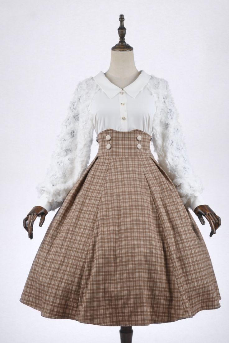 a fulllength photo of a white blouse paired with a brown plaid highwaisted skirt on a mannequin. the blouse features long, sheer sleeves with floral details. the skirt is aline and falls below the knee. the background is a plain white wall, and the lighting is bright and even.