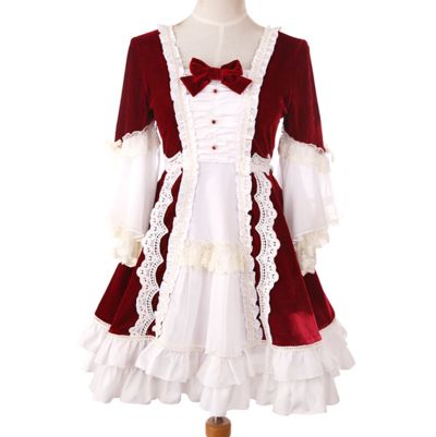 this is a red and white lolita dress with lace trim and a bow at the neckline. the dress has long sleeves and a full skirt. the photo is taken indoors with artificial lighting. the dress is displayed on a mannequin.
