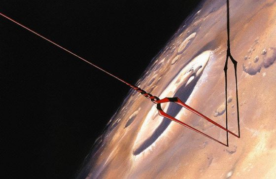 a red spear with a black cable is shown in the upper left hand corner of the image. it is dangling above a brown planet. there is a shadow of the spear on the surface of the planet. the spear has a curved design and has three points at the end.