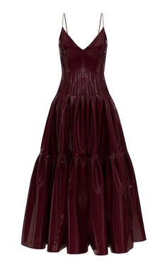 a maroon sleeveless vneck dress with a ruffled satin skirt. the dress is elegant and feminine, perfect for a formal occasion.