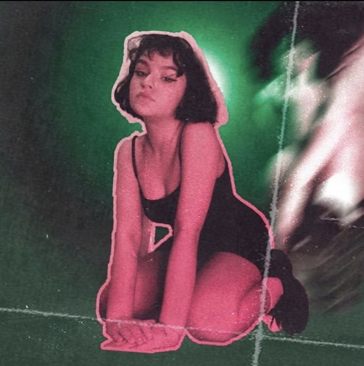 this image features a young woman posing for a photo in a vintage setting.  the woman is wearing a black dress that appears to be either a bathing suit or a slip, and has a retro hair style. the photo is taken with