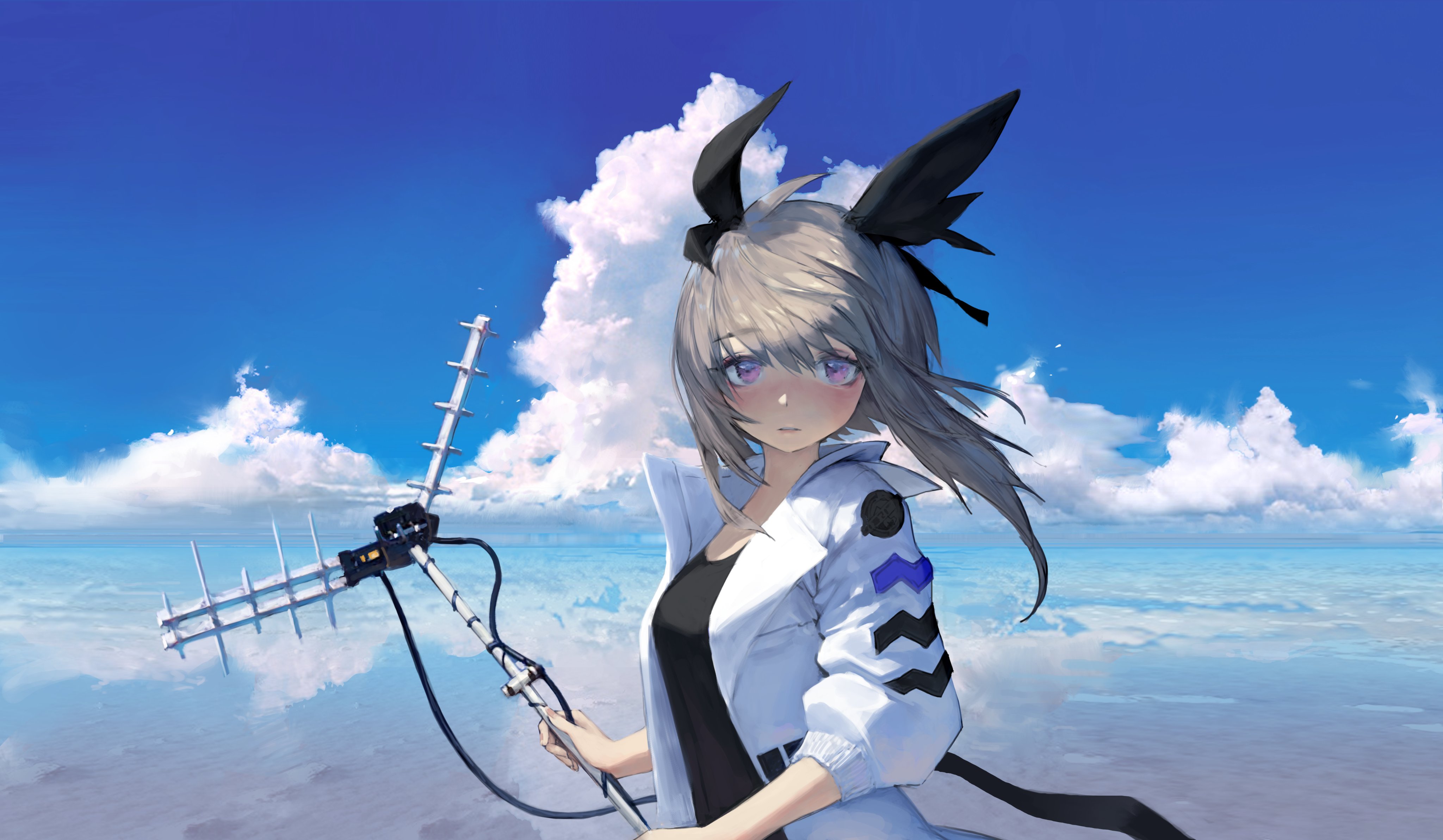 the image is a digital illustration of an anime girl standing on a beach. she has light grey hair with black hair accessories that resemble rabbit ears, purple eyes, and is wearing a white jacket over a black top. she is holding a large antenna. the background is a beautiful ocean scene with a bright blue sky and fluffy white clouds. the overall style is colorful and whimsical.