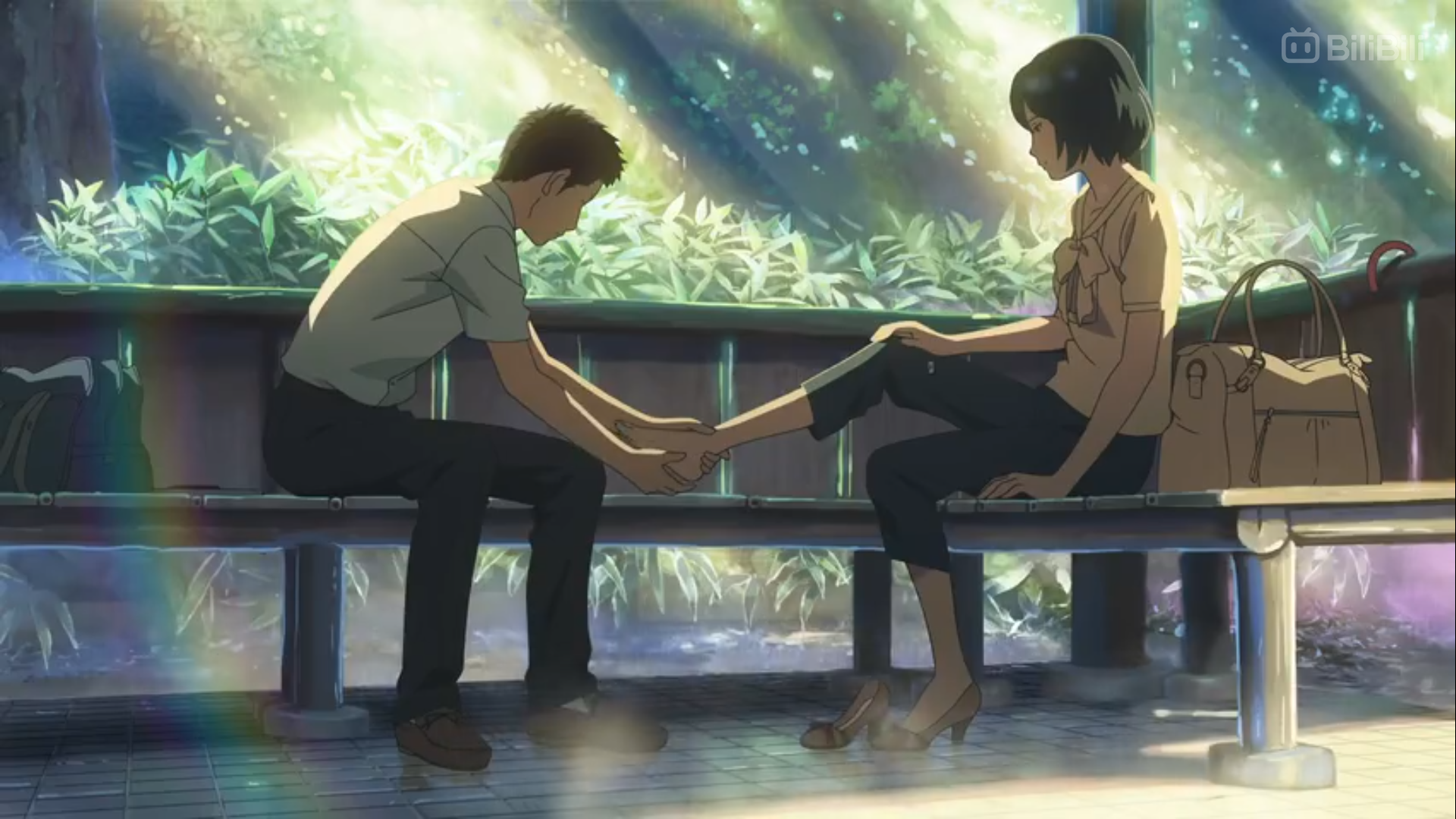 a young man and woman sit on a park bench. the man is gently holding the woman's foot in his hands. sunlight streams through the trees, creating a peaceful and intimate atmosphere.