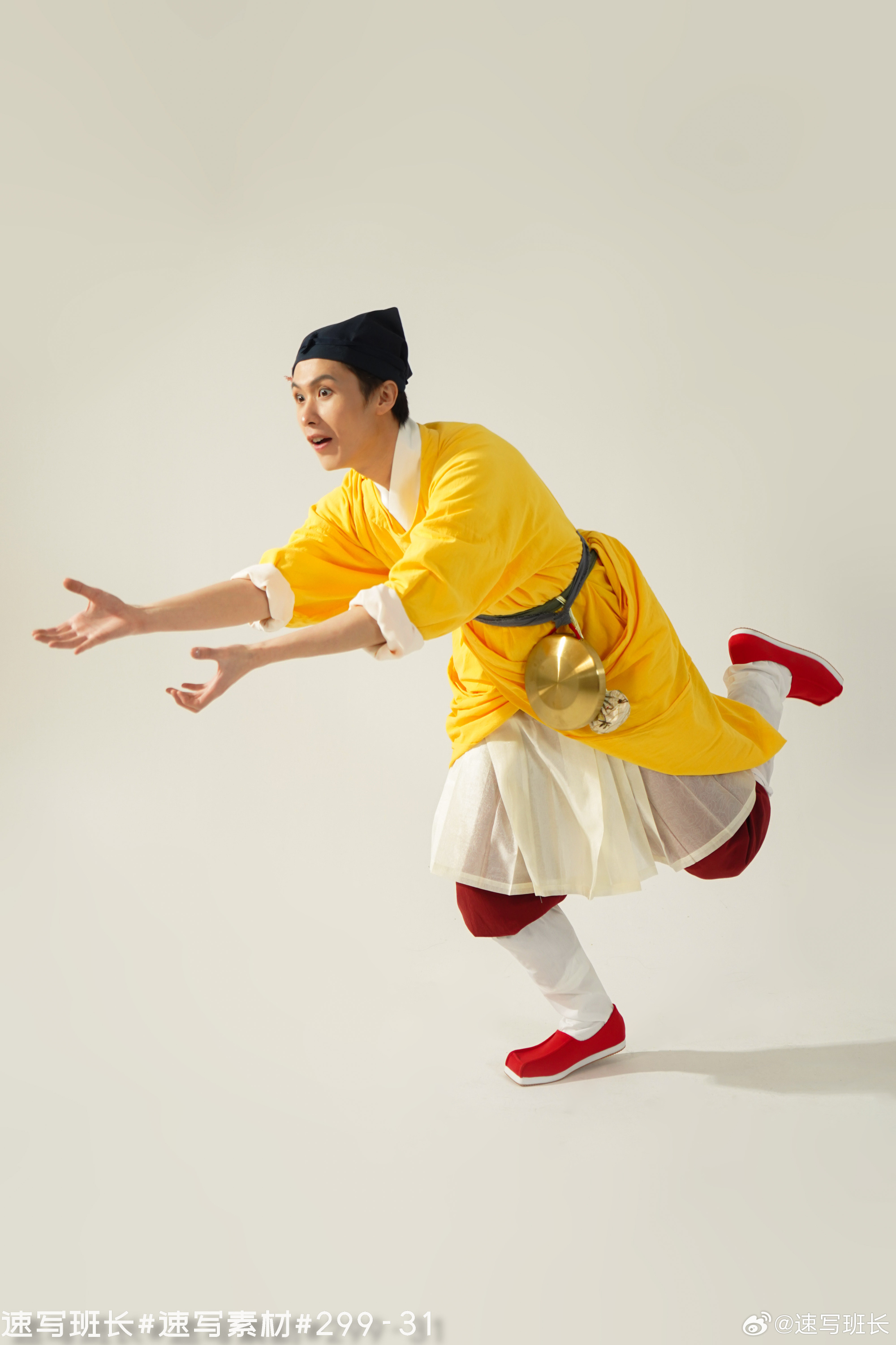 a male actor in a bright yellow traditional chinese opera costume is captured midperformance. he is in a dynamic pose, leaning forward with one leg extended, his arms outstretched as if reaching for something. his facial expression is animated and expressive, suggesting he is fully immersed in his role. the background is a clean, bright white, emphasizing the vibrancy of the costume and the energy of the performance.