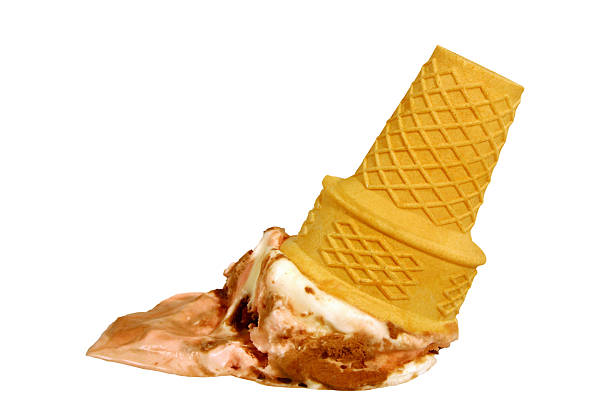 the image shows a dropped ice cream cone.  the cone is a lightyellow waffle cone, and the ice cream appears to be a threeflavor combination: strawberry, chocolate, and vanilla.  a significant portion of the ice cream has melted and spilled onto a white surface. the cone is lying on its side, with the majority of the ice cream now on the surface below it. the overall impression is one of a messy but still appealing dessert mishap.