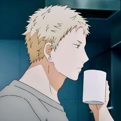 a young man with spiky blonde hair is shown from the chest up, drinking from a white mug. he has a thoughtful expression and is facing towards the right. the scene is set in a kitchen, with muted bluegrey tiles visible in the background. the lighting is soft, creating a gentle atmosphere.