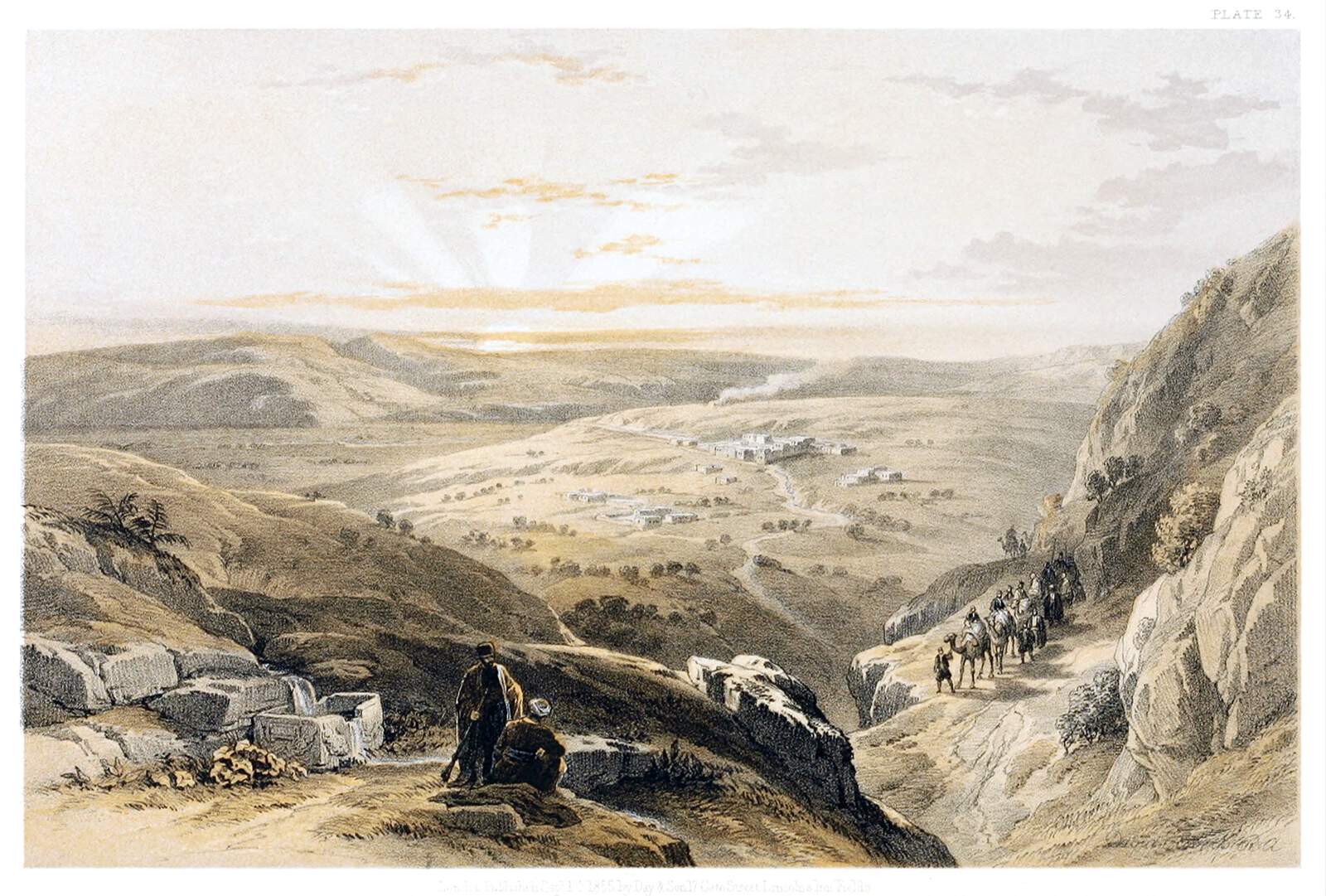 the image depicts a landscape scene, possibly a desert or mountainous region. in the foreground, two people are standing on a rocky overlook. a group of people on camels is traveling down a narrow path between the mountains. in the distance, there is a village or settlement with several buildings. the sky shows a sunrise or sunset with light breaking through the clouds, creating a sense of vastness and distance. the overall impression is that of a historic illustration or print.