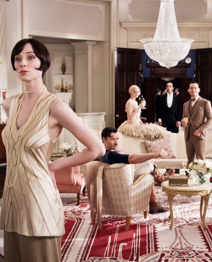 this is an image of a 1920'sstyle party. a woman in a flapper dress stands in the center of the room, smiling and looking at the camera. there are other people in the background, including a couple sitting on a couch, a man holding a glass of champagne, and another woman standing in a white dress. the room is decorated in a classic art deco style, with plush furniture and a grand chandelier. the atmosphere is elegant and celebratory, with a sense of joy and fun.  this image evokes a feeling of nostalgia for the roaring 20s, a time of great social change and economic prosperity.