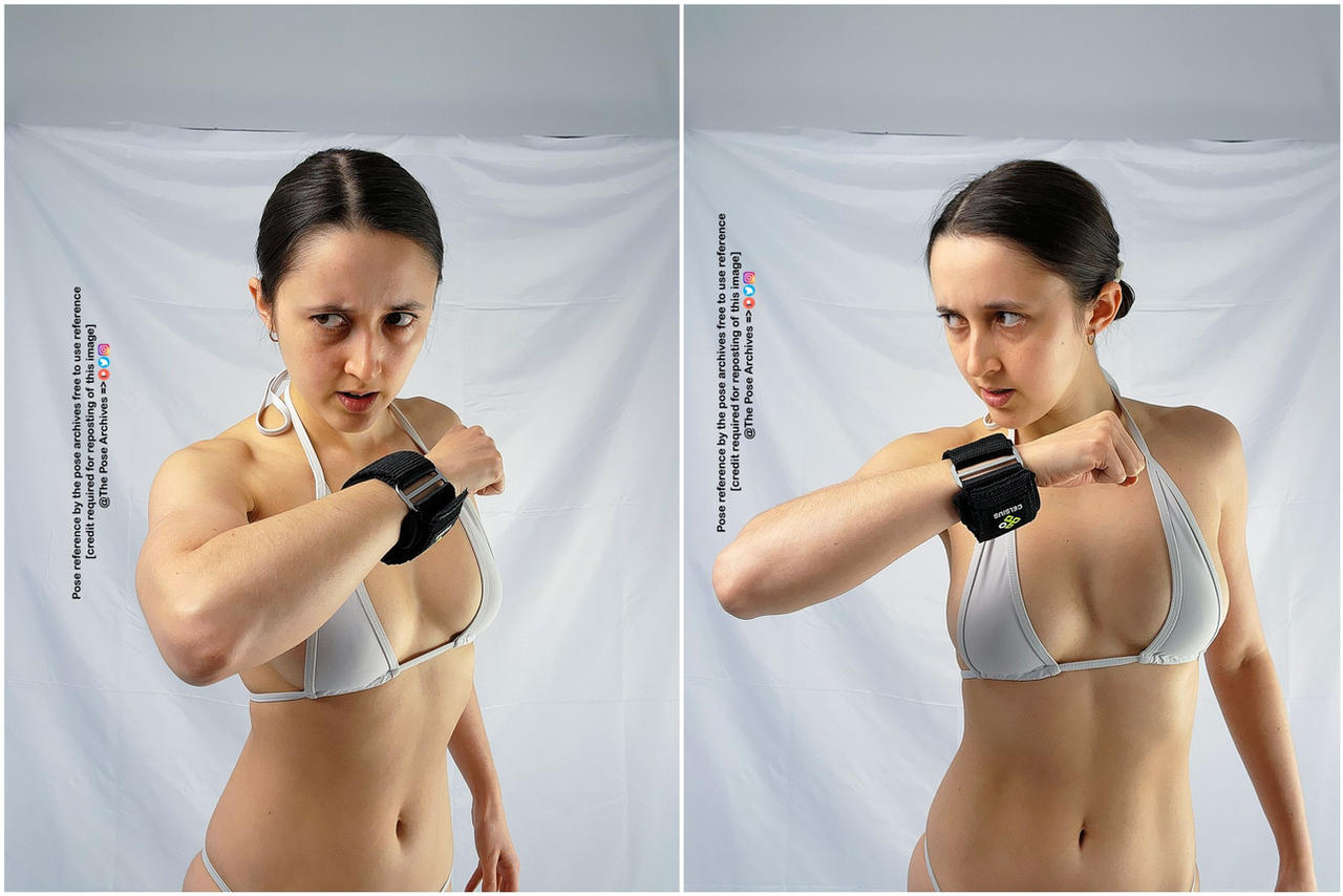 a young woman in a bikini top and wrist weights stands in two different fighting stances against a plain white background.  she appears focused and determined. the bright, artificial lighting illuminates the scene.