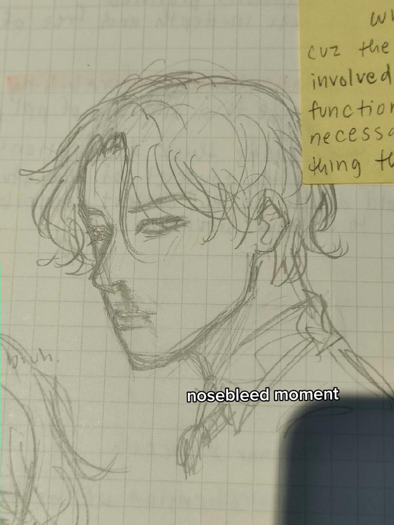 this is a sketch of an animestyle male character on lined paper.  he is shown from the shoulders up in a slight profile. he has messy, mediumlength hair. his eyes are drawn simply with minimal detail. he wears a highcollared shirt or jacket. there's a note next to the figure's face that reads "nosebleed moment." another sketch of a face is partly visible in the lowerleft corner. a yellow sticky note with handwriting is partially covering the top right corner of the sketch. the lighting suggests the photo was taken indoors near a window.