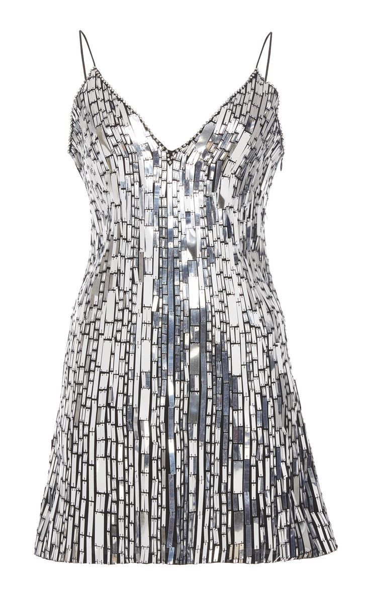a silver sequined dress with a vneck and sleeveless. the dress is short and is covered in silver sequins that create a shimmering effect.