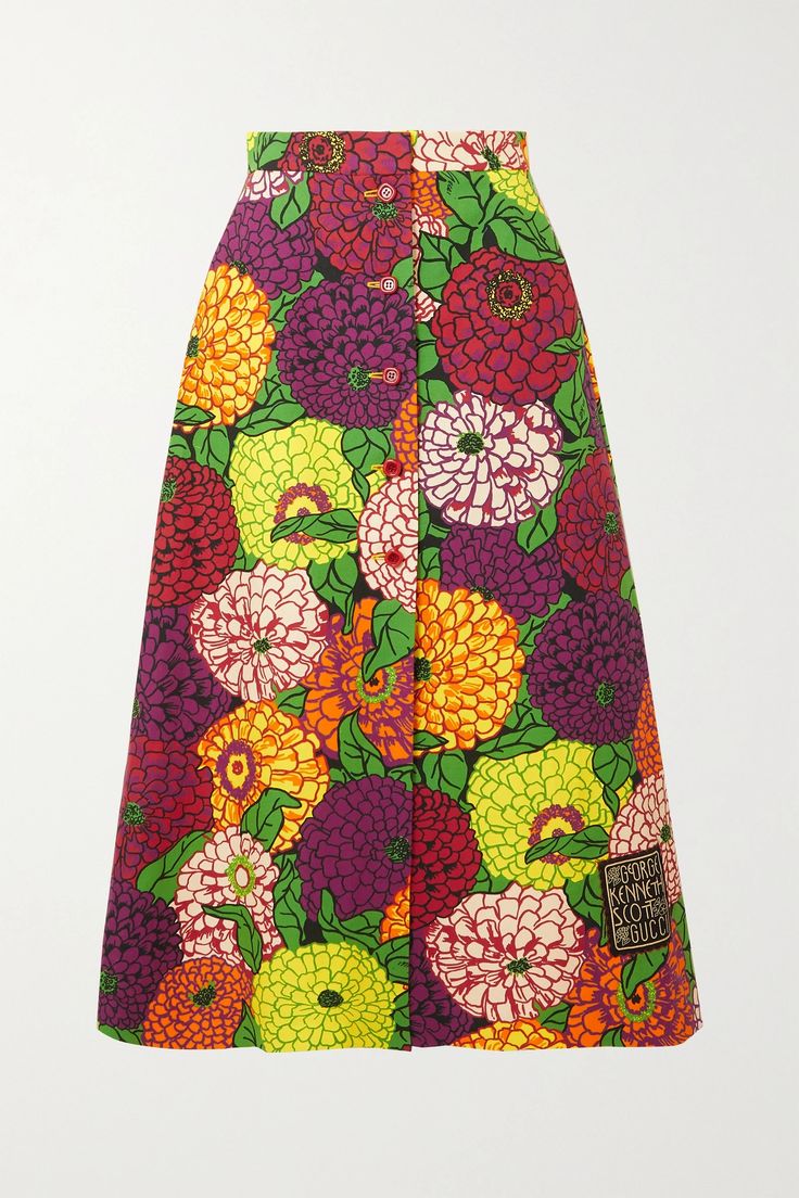 a gucci x ken scott floralpatterned midi skirt with large multicolored flowers and a brand patch near the bottom.