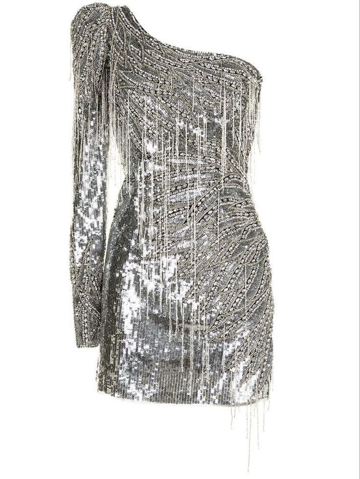 a silver, shimmering mini dress is showcased against a stark white background. the dress features one long sleeve on the left side and is cut asymmetrically across the chest, leaving the right shoulder bare. it is heavily adorned with sequins and fringes that create a dazzling, textured appearance. the fringes hang vertically, adding movement and depth to the dress. the overall style is glamorous and partyready, suggesting a piece intended for evening events.