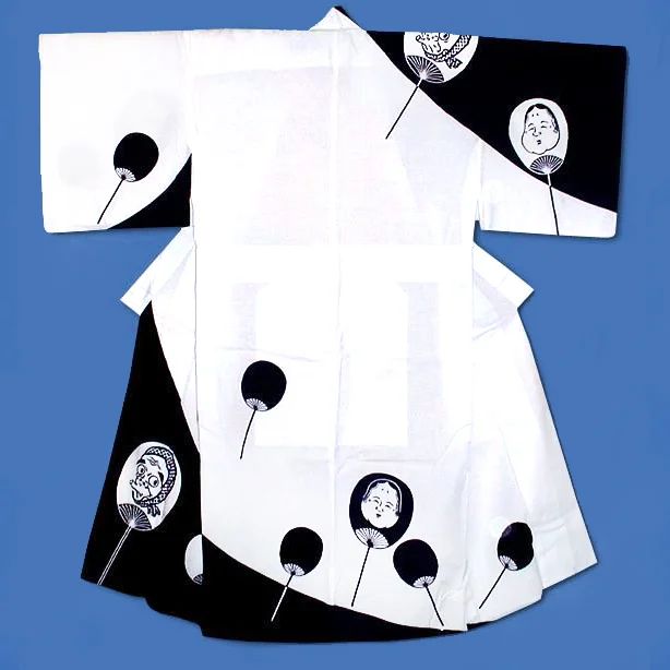 a kimono with a black and white pattern, featuring fan designs, some with faces on them.