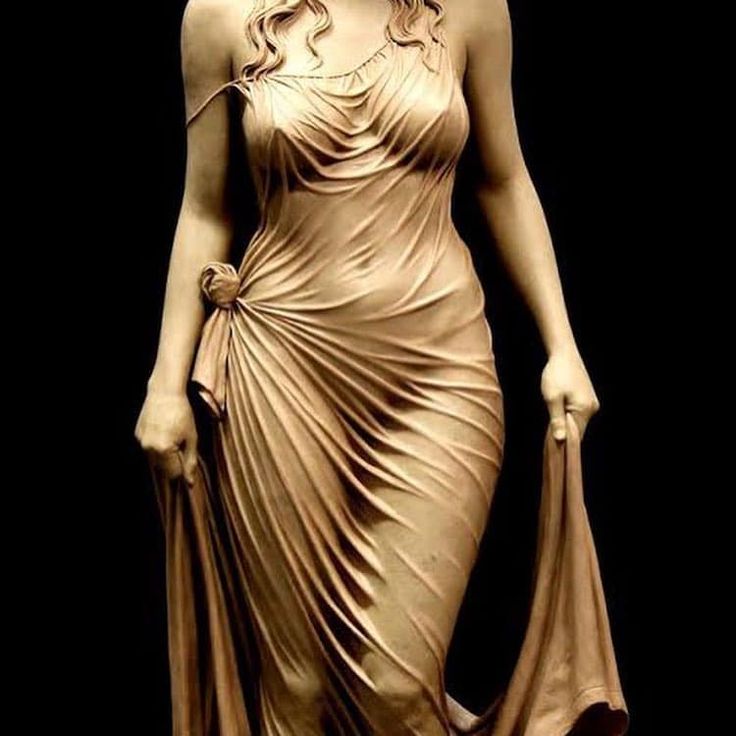 the image shows a beautifully crafted sculpture of a woman in a flowing dress. the sculpture is highly realistic, capturing the delicate folds and textures of the fabric. the woman's pose is elegant and graceful, with her body slightly turned and her arm outstretched. the lighting is soft and diffused, highlighting the contours of the sculpture.