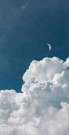 a breathtaking image of a beautiful, serene sky with fluffy white clouds and a thin crescent moon. the sky is a deep blue, creating a stunning contrast with the bright white clouds. the clouds are soft and inviting, suggesting a peaceful and calm atmosphere. the crescent moon adds a touch of magic and mystery to the scene. the image is perfect for anyone who wants to feel a sense of peace and tranquility.