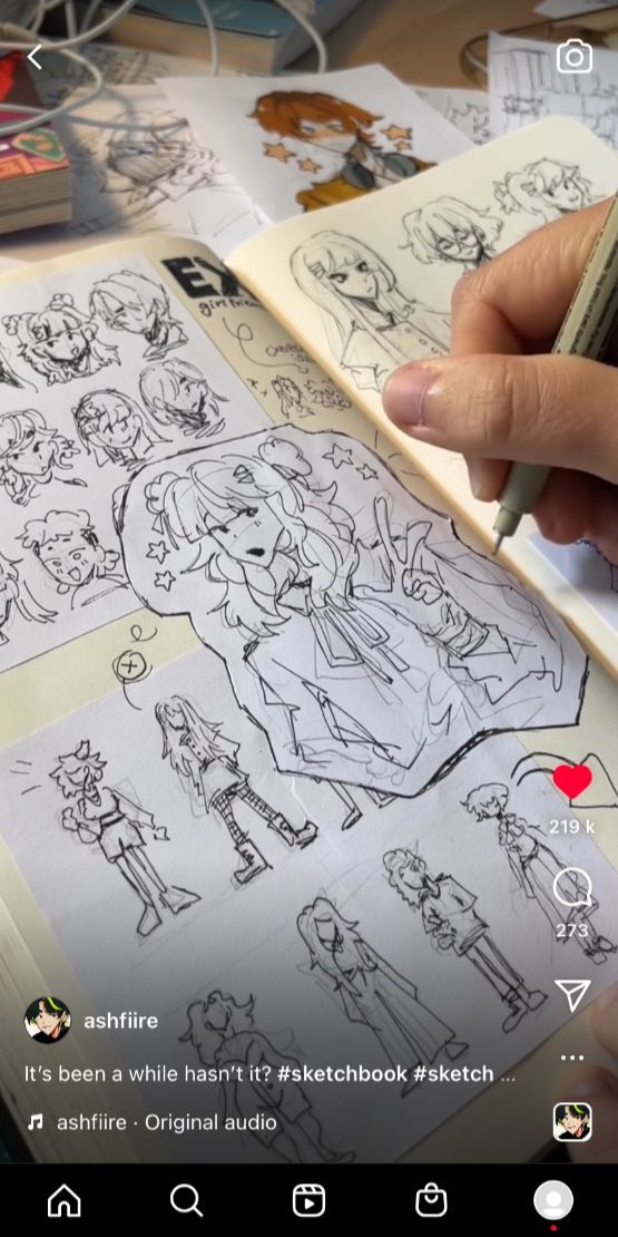 a person is holding a sketchbook open to a page filled with ink sketches of animestyle characters. the person is using a pen to draw another character on the page. the bottom of the image includes a social media caption with the hashtags #sketchbook #sketch.  the top of the image shows the cover of the sketchbook and other drawings on the page. there are many other sketches of animestyle characters on the page in various poses.
