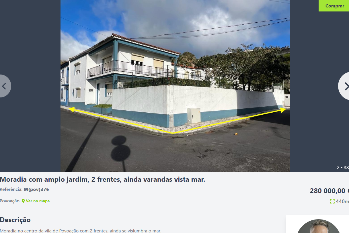 the image shows the exterior of a twostory house with a large garden. the house is located on a street corner and has a white wall with a blue trim. there is a driveway leading up to the front of the house. the house has a balcony on the second floor. there is also a fence surrounding the property. the image is likely a real estate listing for the house. the listing price is 280,000.00 euros and the property is located in the village of povoação, portugal.
