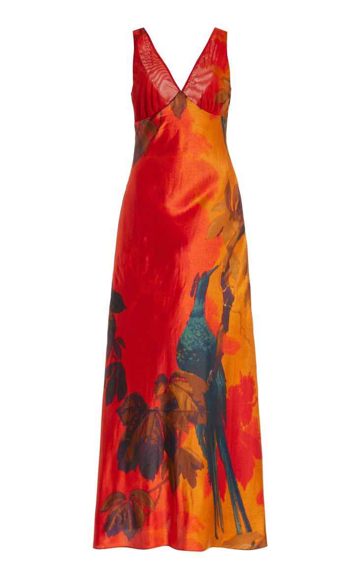 a beautiful, elegant red and orange maxi dress with floral and bird prints. the dress is made of satin or silk and has a vneckline and sleeveless design. it is perfect for special occasions or summer evenings. the flowing fabric and vibrant colors make this dress a real headturner.