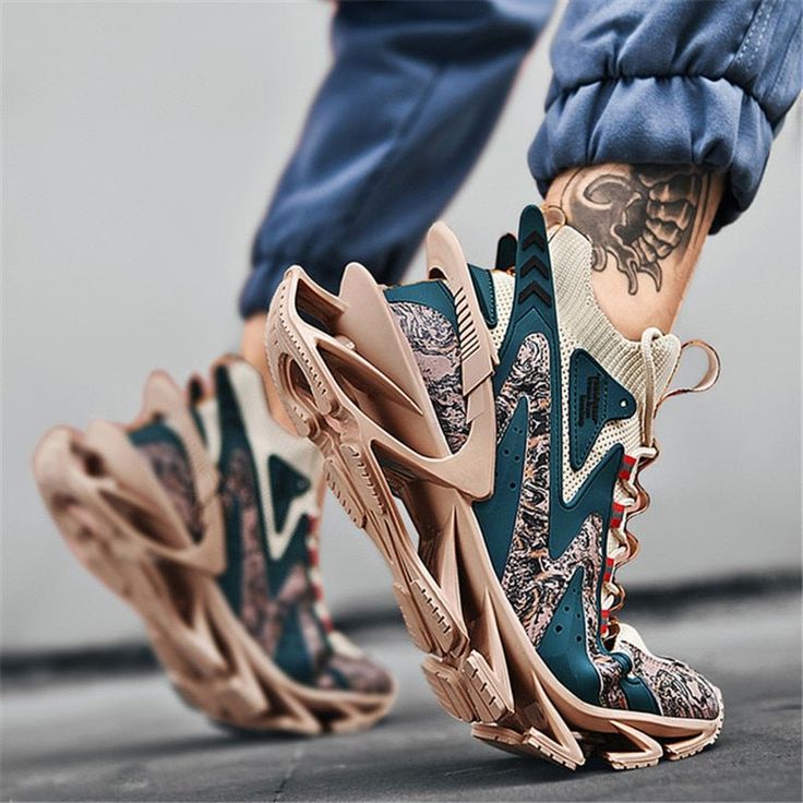 a closeup shot of a person's legs wearing a pair of trendy sneakers. the shoes are teal and white with gold accents. the person is wearing blue jeans and the shoes have a unique design. the shoes are casual and stylish. the person is walking and the shoes are in focus. the shoes are trendy and popular.