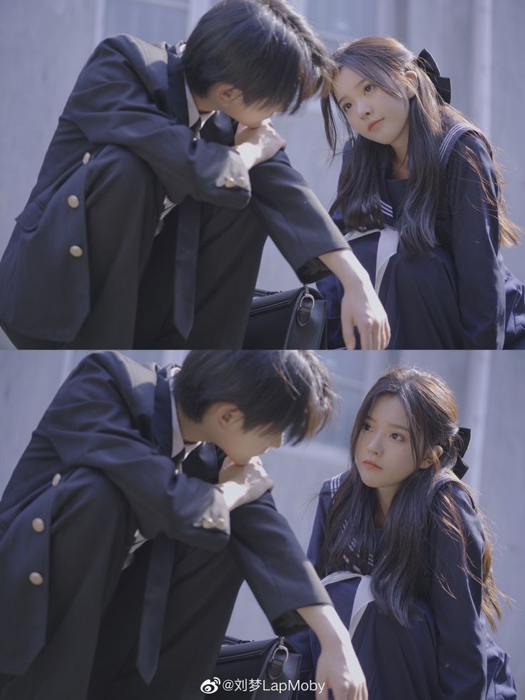 the image shows a young boy and girl seated outside. both are wearing school uniforms. the boy is sitting with his head resting on his arms, appearing pensive or worried. the girl is looking at the boy with a concerned expression. both appear to be asian.