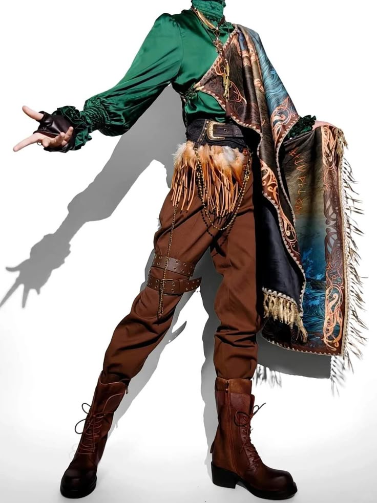 an image depicts a person wearing a detailed and elaborate cosplay costume standing in front of a white wall. the costume features a green satinlike shirt with ruffled cuffs, brown pants with leather straps, and brown laceup boots. the outfit includes a wide black belt adorned with a silver buckle, and a shawl draped over one shoulder. additional details include feather accents, decorative chains, and dark gloves. the shadow of the person is also visible on the white wall.