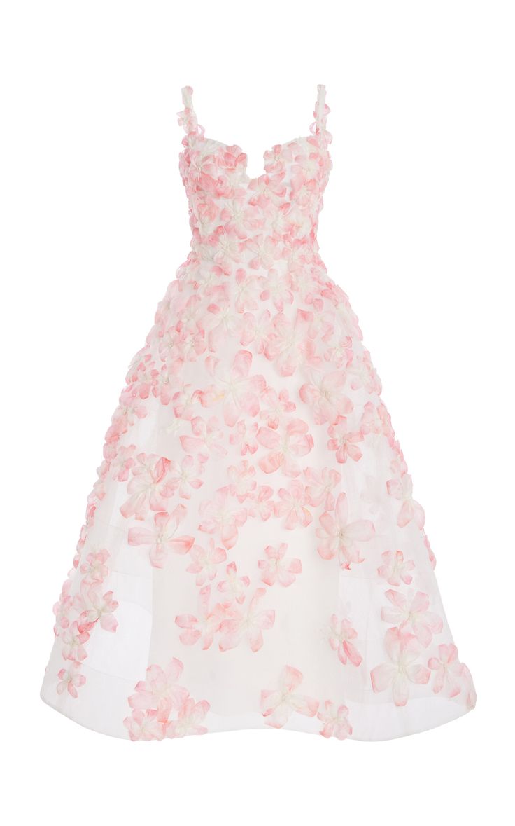 a white ball gown with pink flowers is shown on a white background. the dress is sleeveless and has a vneck. the pink flowers are scattered all over the dress.
