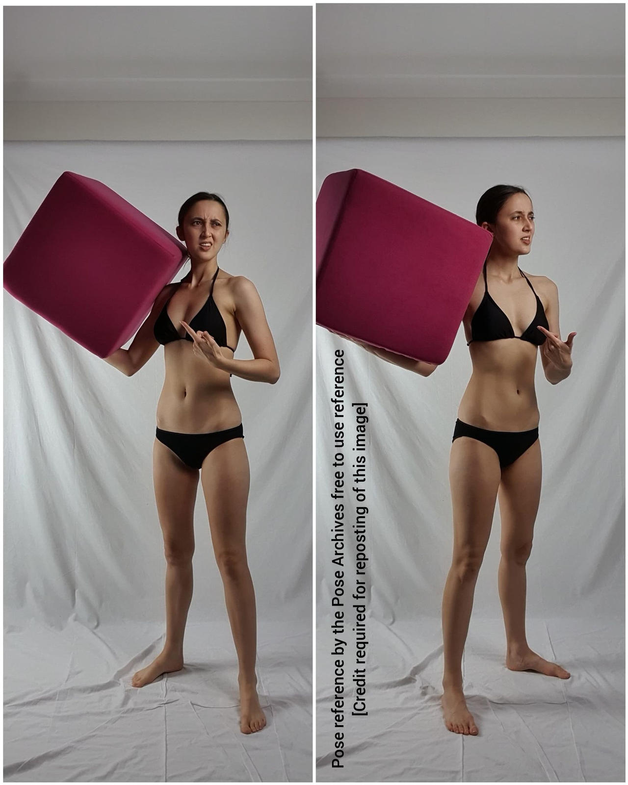 a woman is posing in front of a white background, holding a large pink cube. she is wearing a black bikini and is looking at the camera with a determined expression on her face. the image is a reference photo for artists.```