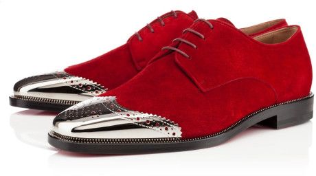 a pair of men's red suede shoes with silver metal detail. the shoes are formal and elegant with a brogue design. the shoes are a classic style for men who want to look sharp and stylish.