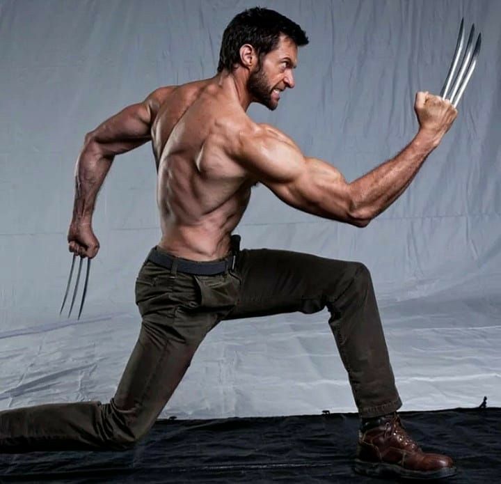 a shirtless muscular man with claws extended posing in a fighting stance.