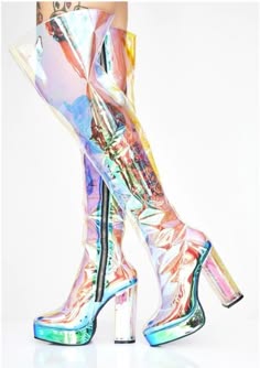 a pair of iridescent transparent over the knee boots on a white background. the boots are highheeled, platform boots with a holographic pattern. the boots are clear and have a silver zipper on the back. they are stylish and trendy and would be perfect for a night out or a special occasion.