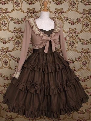a brown lolita fashion dress with a matching bolero is displayed on a mannequin. the dress has a tiered skirt and is paired with a lacetrimmed bolero. the background features a floral wallpaper.