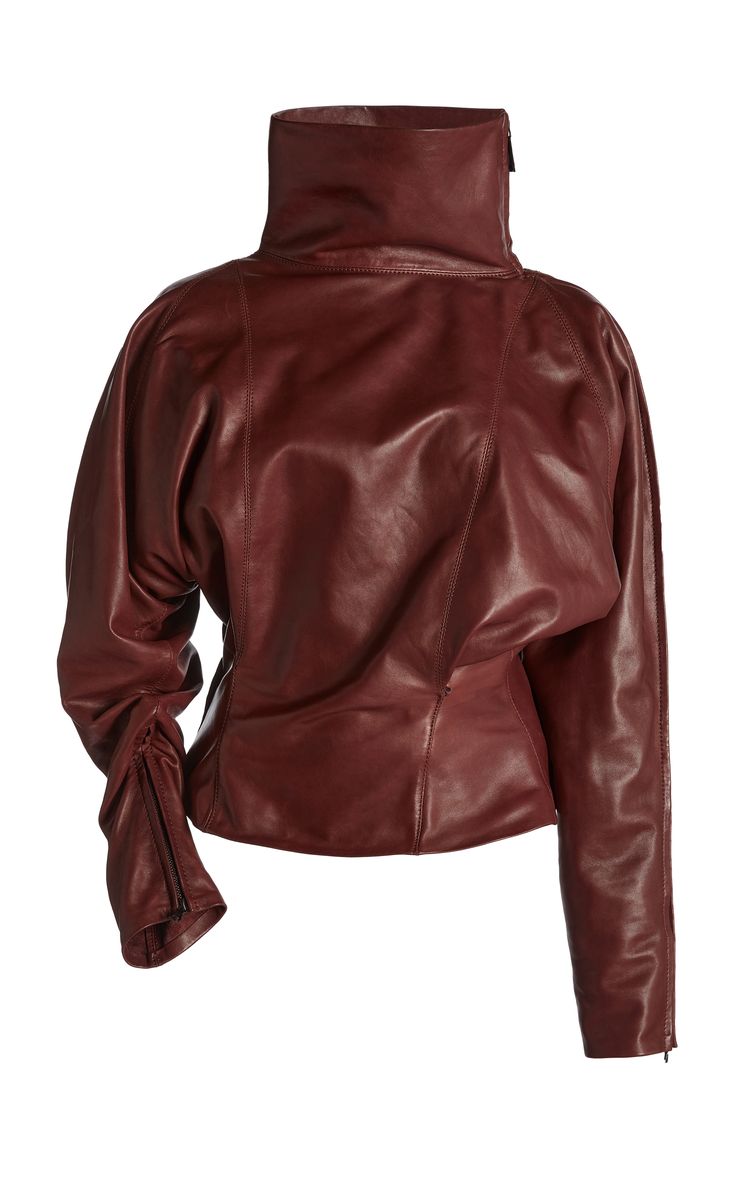 a maroon, highnecked leather jacket with fitted sleeves that are slightly gathered at the cuffs. the jacket is a cropped style and has a cinched waist, adding to its sleek and stylish appeal.