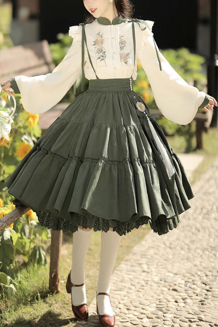 a woman wearing a vintageinspired outfit, consisting of a white embroidered blouse and a flowing green skirt.  the photo is taken outdoors in a garden setting, bathed in soft, natural sunlight.  the perspective is at eye level, capturing the details of the outfit and the romantic ambiance.