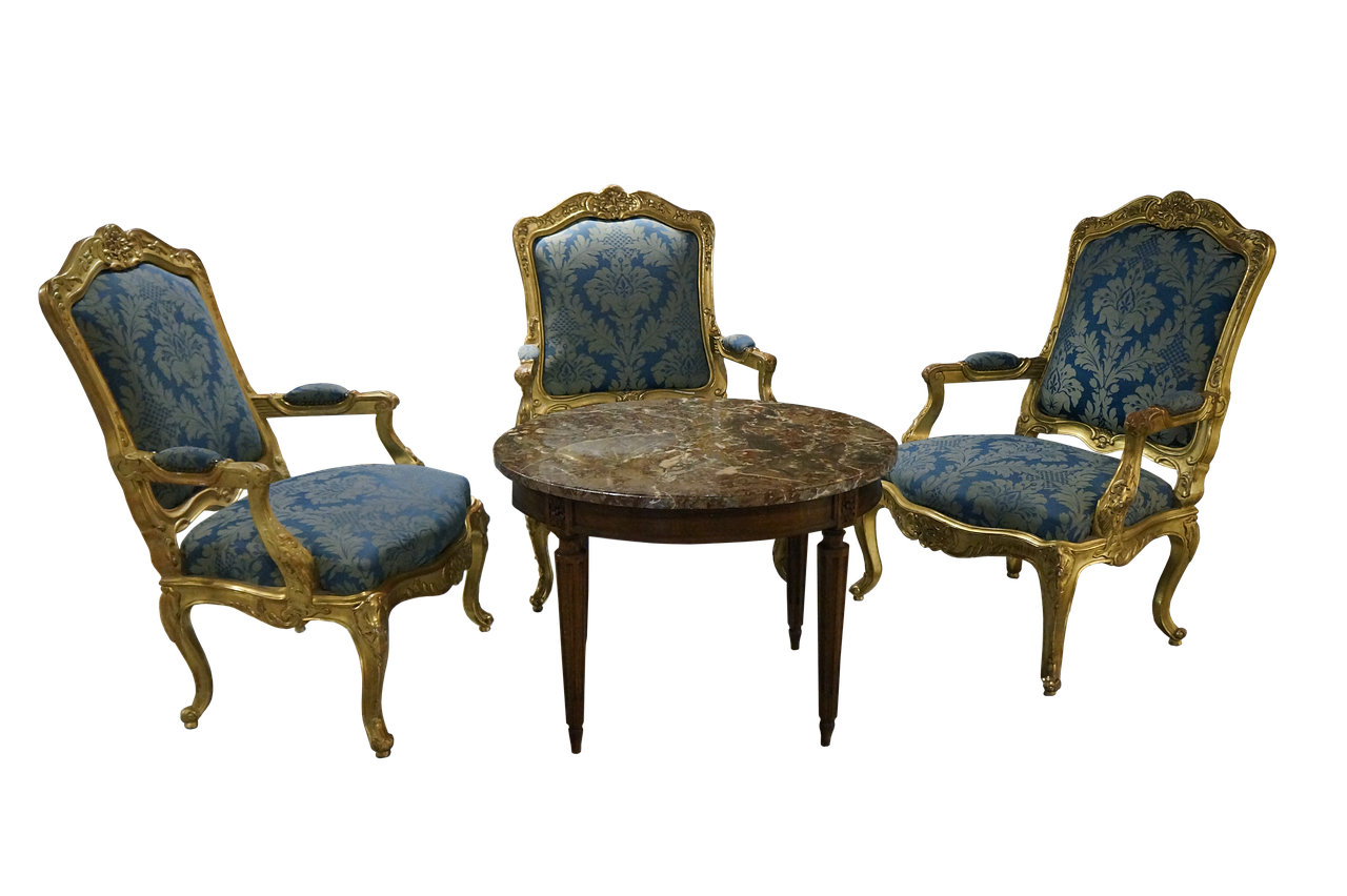 the image shows a set of antique furniture against a black background. there are three armchairs with ornate gold trim and blue upholstery featuring a floral pattern. a round table with a marble top stands between the armchairs. the furniture is likely from a historical period and appears to be of high value.