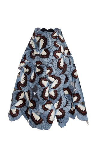 a stylish blue floral lace midi skirt is displayed against a plain white background. the skirt features a repeating pattern of stylized floral shapes with intricate lace details.