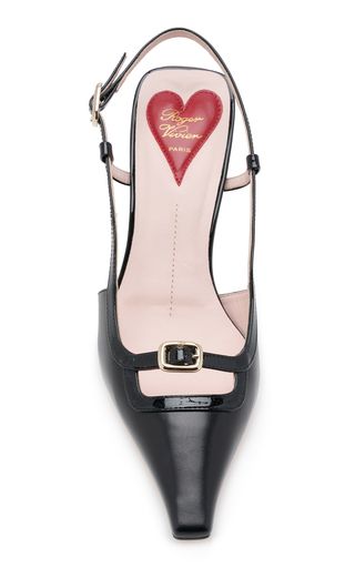 a pair of black patent leather pointy toe heeled pumps with a heart on the insole, a buckle, and a slingback. the pumps are from the brand rogers vivier.