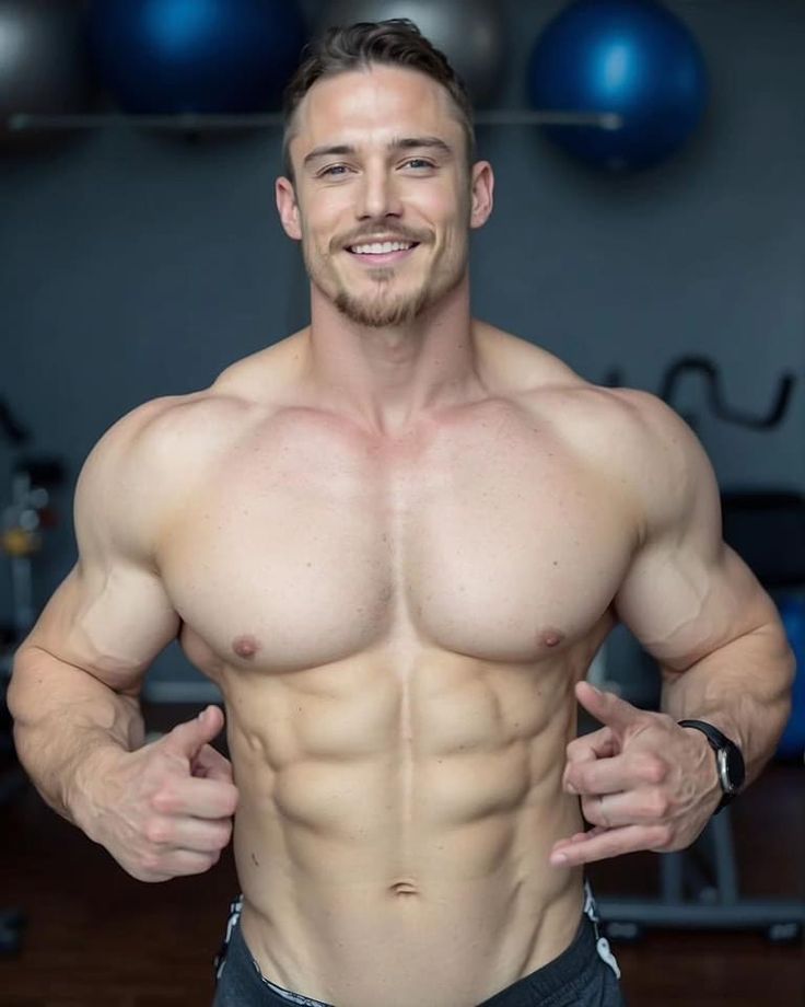 a muscular man is showing off his sixpack abs in a gym setting. he is wearing a black athletic shirt. the man's physique is a testament to hard work and dedication to fitness. he looks confident and motivated, ready to conquer his next workout.