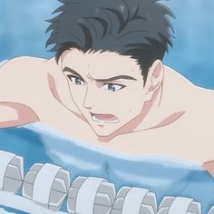a closeup image featuring a young man in an indoor swimming pool.  the perspective is slightly below the waterline, capturing him from the chest up. he has short, dark hair plastered to his forehead, and his expression is one of exertion with his mouth open, likely in midbreath. the background features the light blue tiles and lane dividers common to swimming pools.  the overall lighting is soft, suggesting natural light filtering through a nearby window. the art style is characteristic of anime or manga.